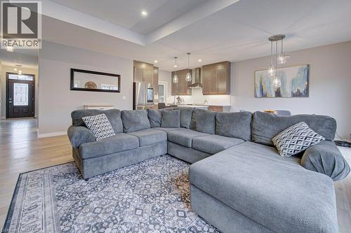 Open-concept living space featuring wood-finish flooring, recessed lighting, and a tray ceiling - 15 Matheson Crescent, Innerkip, ON - Indoor Photo Showing Living Room
