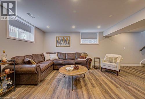 Spacious lower-level room featuring wood-finish flooring, recessed lighting, and neutral wall tones - 15 Matheson Crescent, Innerkip, ON - Indoor