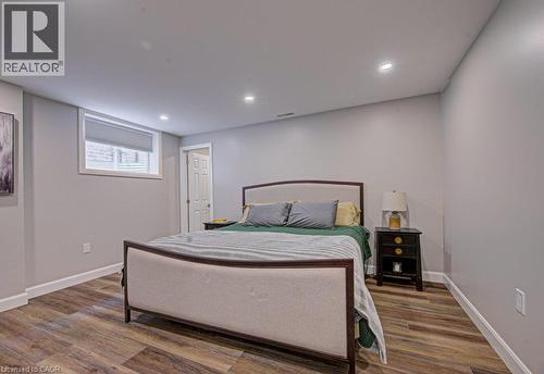 Recessed lighting illuminating wood-finish flooring, light grey walls, and a white trim - 15 Matheson Crescent, Innerkip, ON - Indoor Photo Showing Bedroom
