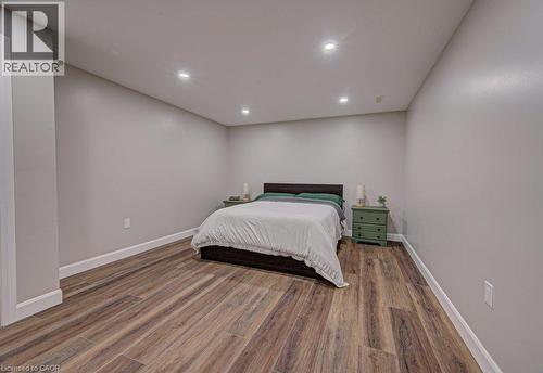 Spacious room featuring wood-finish flooring, recessed ceiling lighting, light gray walls, and white baseboards - 15 Matheson Crescent, Innerkip, ON - Indoor Photo Showing Bedroom