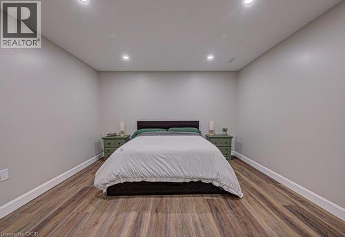Spacious room with wood-finish flooring, recessed ceiling lighting, and crisp white baseboards - 15 Matheson Crescent, Innerkip, ON - Indoor Photo Showing Bedroom