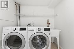 Dedicated laundry area featuring a utility sink, wire shelving, and durable tile flooring - 