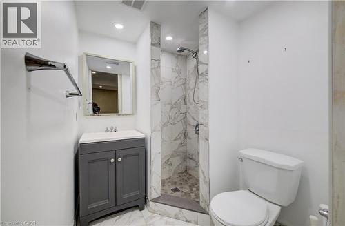 Contemporary bathroom featuring a walk-in shower with marble-look wall tile and a hexagonal floor - 80 Miranda Path, Elmira, ON - Indoor Photo Showing Bathroom