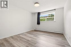 Light wood-finish flooring complements the neutral wall color - 
