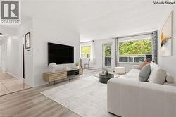 Bright living area featuring wood-finish flooring and a large window - 