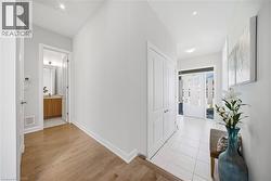 Corridor with baseboards and light wood-style flooring - 