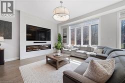 Living room featuring wood finished floors and a fireplace - 