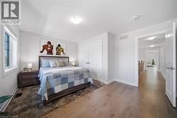 Bedroom with hardwood / wood-style flooring and a closet - 