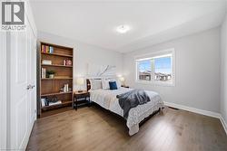 Bedroom with wood finished floors and baseboards - 