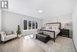 Bedroom with baseboards and light wood-style flooring - 