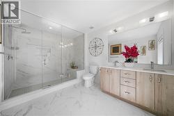 Full bath with light marble finish flooring, double vanity, and a marble finish shower - 