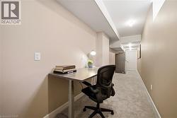 Office space featuring light colored carpet and baseboards - 
