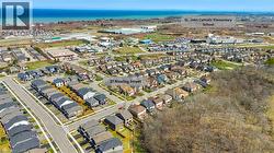 Aerial view of property and surrounding area with nearby suburban area and a large body of water - 