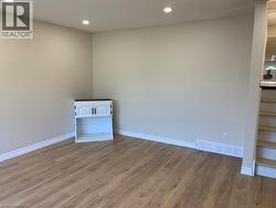 Light wood-finish flooring complements neutral wall tones - 