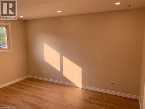 Neutral wall color with recessed ceiling lighting, wood-finish flooring, and white baseboards - 86 Belwood Crescent, Kitchener, ON - Indoor Photo Showing Other Room