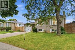 Light-colored brick exterior with a single-car garage and a paved driveway - 