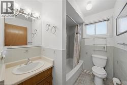 Bathroom with a single vanity, integrated sink, and an overhead light fixture - 