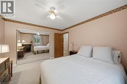 Bedroom with light-colored walls and patterned border trim - 