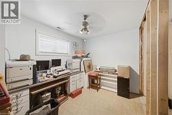 Room featuring a window with blinds, ceiling fan with light fixture, and exposed wood framing - 