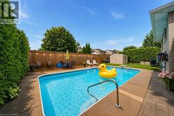 In-ground swimming pool with concrete surround - 