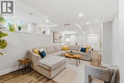 Spacious room featuring wood-finish flooring, recessed lighting, and bright white walls - 