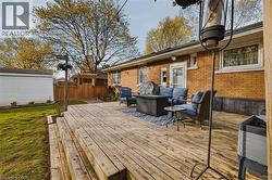 Expansive backyard wood deck with multiple levels and a brick exterior - 
