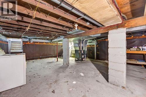 Unfinished basement with exposed ceiling joists and concrete flooring - 23 Harrison Avenue, Hamilton, ON - Indoor Photo Showing Basement