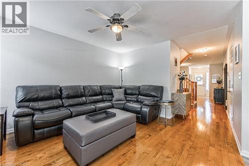 Living area featuring wood-finish flooring, light gray wall paint, and a ceiling fan with integrated lighting - 4057 Donnic Drive, Burlington, ON - Indoor Photo Showing Living Room