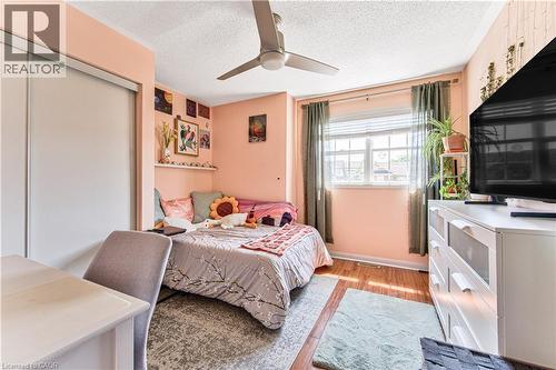 Bedroom featuring a window with blinds, wood-finish flooring, and a ceiling fan - 4057 Donnic Drive, Burlington, ON - Indoor Photo Showing Bedroom