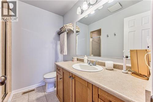Bathroom featuring a vanity with a laminate countertop, wood cabinetry, and a single basin sink - 4057 Donnic Drive, Burlington, ON - Indoor Photo Showing Bathroom