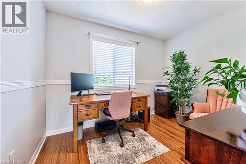 Room featuring wood-finish flooring, a single window with horizontal blinds, and crown molding - 4057 Donnic Drive, Burlington, ON - Indoor Photo Showing Office