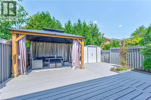 Expansive backyard deck featuring a gazebo with privacy curtains, a storage shed, and a raised garden planter - 4057 Donnic Drive, Burlington, ON - Outdoor With Deck Patio Veranda