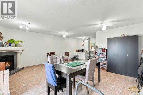 209 215 Lowe Road, Saskatoon, SK - Indoor Photo Showing Dining Room With Fireplace