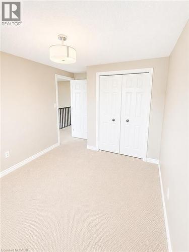 Carpeted room with neutral wall tones and white baseboards - Upper-313 Featherstone Crescent, Kitchener, ON - Indoor Photo Showing Other Room