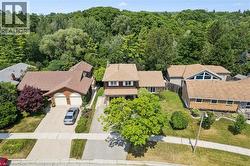 Two-story residence featuring a brown shingle roof, light brown siding, and a prominent front-facing gable - 