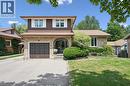 Brown and brick exterior featuring an arched entryway, integrated garage, and a paved driveway - 8 Perin Place, Kitchener, ON  - Outdoor 