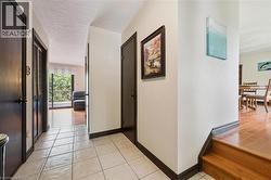 Neutral-toned walls with dark trim, featuring a tiled entryway - 