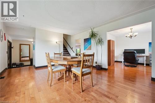 Hardwood flooring throughout featuring a spacious dining area with a round wood table - 8 Perin Place, Kitchener, ON - Indoor Photo Showing Dining Room