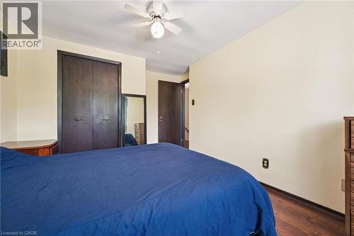Bedroom featuring wood-finish flooring, light-toned walls, and a ceiling fan with integrated lighting - 8 Perin Place, Kitchener, ON - Indoor Photo Showing Bedroom