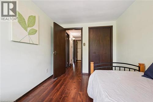 Wood-finish flooring extending through the hallway - 8 Perin Place, Kitchener, ON - Indoor Photo Showing Bedroom