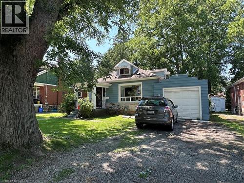 Blue siding exterior with stone accenting, a front porch, and a dormer window - 9 Norfolk Street N, Hamilton, ON - Outdoor