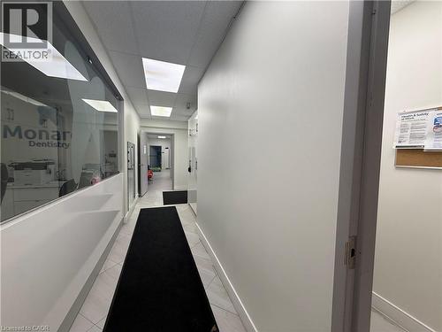 Hallway featuring tiled flooring, recessed ceiling lighting, and a frosted glass wall - 51 Benton Street, Kitchener, ON 