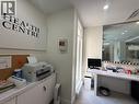 Bright reception area featuring a large window, built-in desk, and overhead recessed lighting - 51 Benton Street, Kitchener, ON 