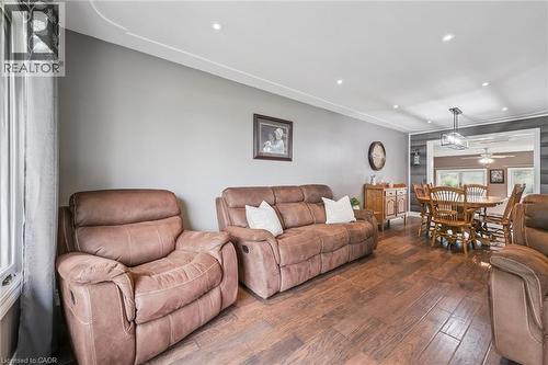 Open concept living area featuring dark wood-finish flooring, recessed lighting, and crown molding - 7988 Wellington Road 12, Arthur, ON - Indoor Photo Showing Living Room
