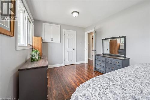 Bright interior space featuring wood-finish flooring, light grey walls, and white trim - 7988 Wellington Road 12, Arthur, ON - Indoor Photo Showing Bedroom