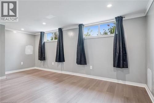 Spacious room featuring light wood-finish flooring, recessed lighting, multiple windows, and crown molding - 7988 Wellington Road 12, Arthur, ON - Indoor Photo Showing Other Room