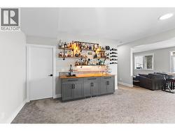 Expansive family room featuring a beautifully appointed bar area, ideal for entertaining or creating your own games and recreation space. - 