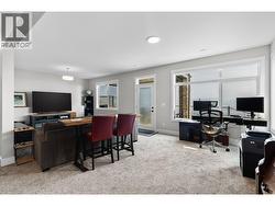 Spacious lower level family room offering the perfect space to relax, watch movies, or gather with family and friends. - 