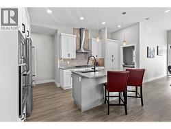 Thoughtfully designed gourmet kitchen featuring quartz countertops, quality stainless steel appliances, abundant cabinetry, and a large island perfect for entertaining. - 