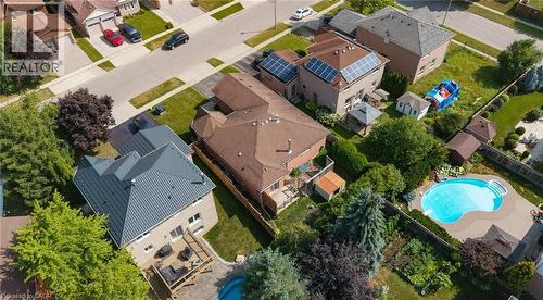 Contemporary residence featuring a dark gray metal roof and a spacious rear deck - 60 Attwood Drive, Cambridge, ON - Outdoor With View